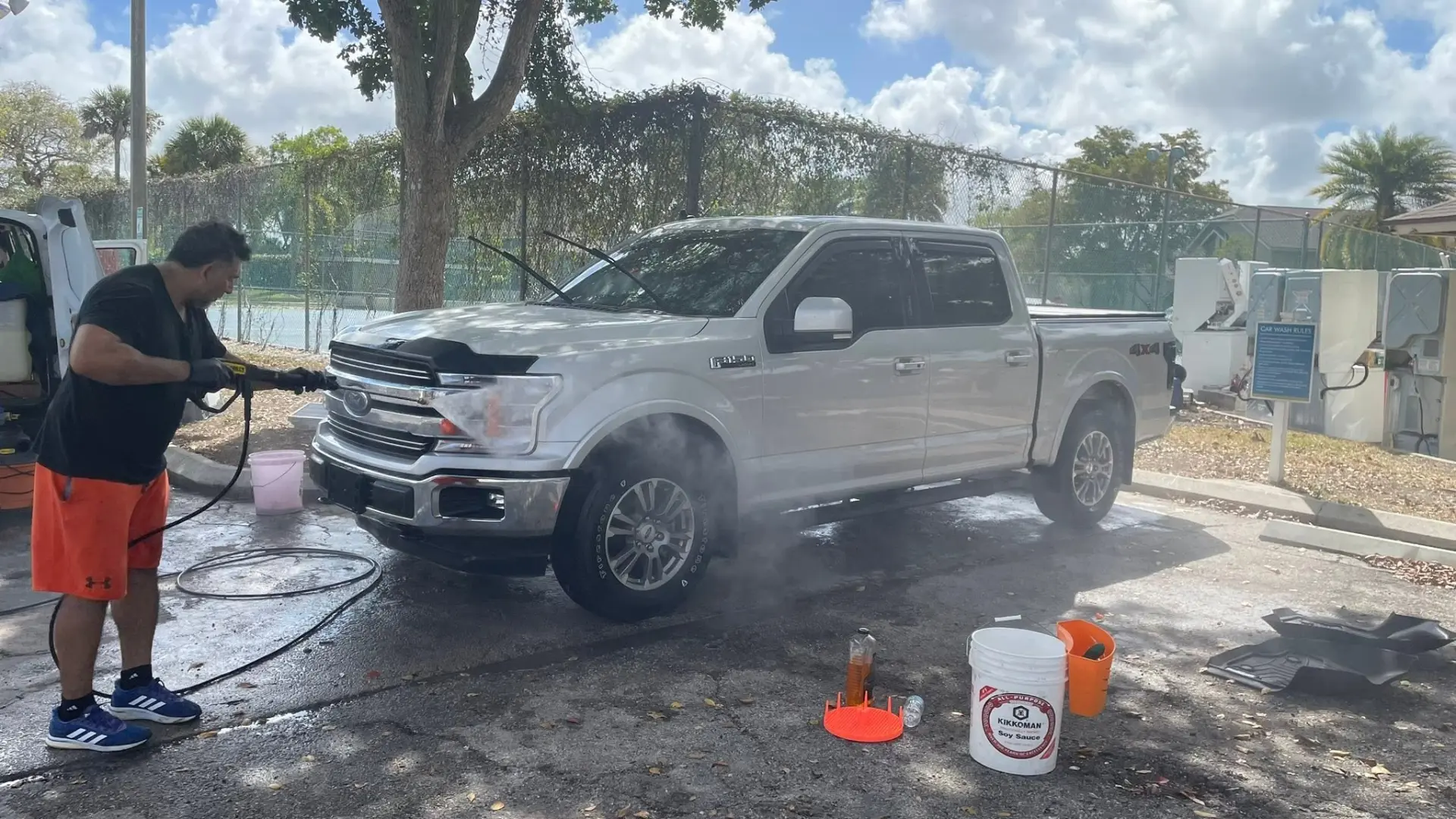Owner pressure washing a pickup truck